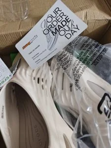 Cream clogs still part-wrapped in the delivery box