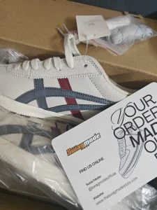 Cream retro runners with navy and red stripes, fresh out of the box