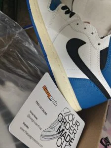 A blue and white high-top sneaker photographed on delivery