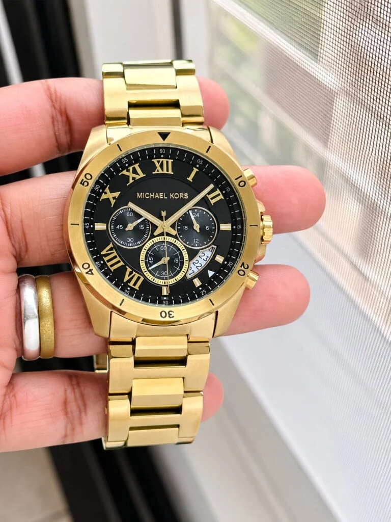 Gold-tone 45mm chronograph watch with a black Roman-numeral dial and steel bracelet