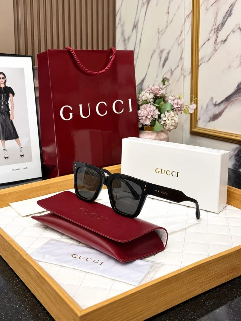 Black square acetate sunglasses beside their case