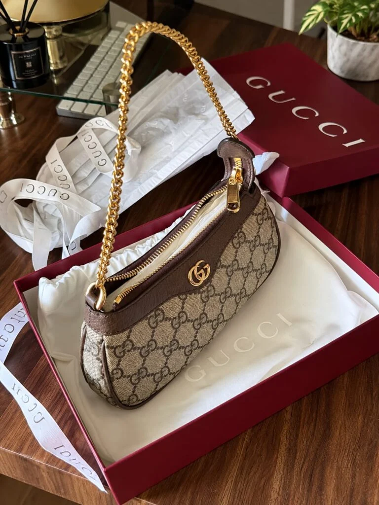 Mini monogram-canvas shoulder bag with leather trim and a gold chain