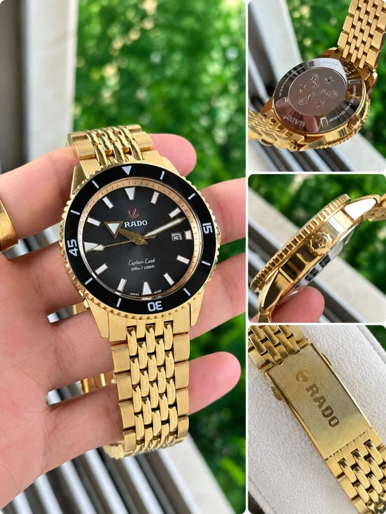 Gold-tone 42mm automatic dive watch with a black dial and black ceramic bezel