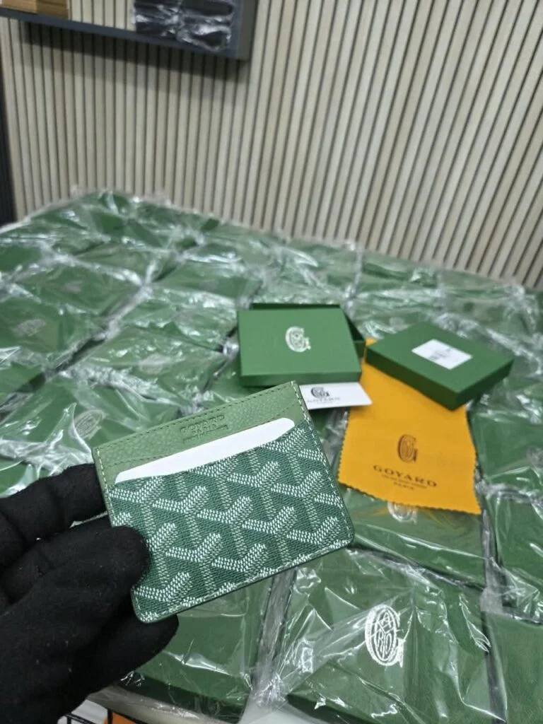 Slim card holder in green monogram-coated canvas with leather trim