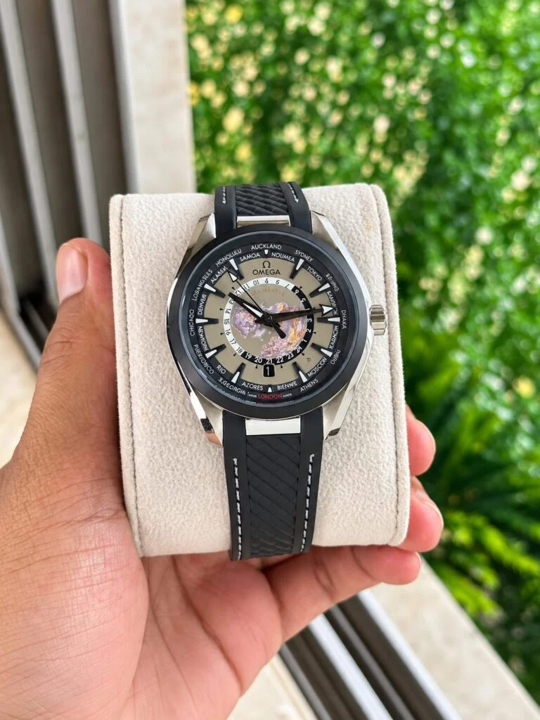 World map automatic watch with a grey dial, black bezel and black rubber strap